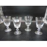 Three crystal wine glasses and another with nick to the rim,