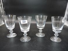 Three crystal wine glasses and another with nick to the rim,