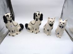 A pair of black & white mantle spaniels (11 1/2" tall) and a pair of cats with similar design;