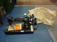 An old manual Singer sewing machine with soft cover.