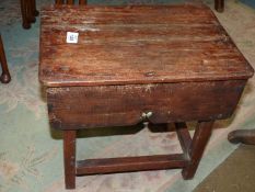 A dark stained wood rectangular Stool and having square legs united by perimiter stretchers and
