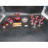 A small quantity of cranberry glass including set of six glasses, small jug, frill rimmed vase etc.