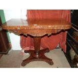 A 19th century Regency design Mahogany flap over card table standing on a tapering octagonal pillar