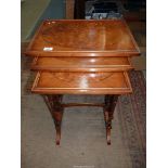 A Nest of Three spindle legged Occasional Tables, the tops with oval Burr wood centres,