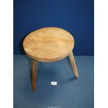 A Three legged milking stool, 10 1/4" diameter x 12 1/2" high.