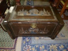 An unusually dark stained Camphorwood Chest decorated with carved scenes of oriental life amidst