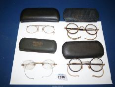 Four pairs of cased spectacles.