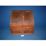 A mahogany Desk Tidy with two doors opening to reveal letter rack and lower drawer,