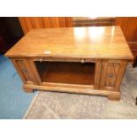 A mid Oak TV stand with a glazed doored compartment and recessed store shelf,