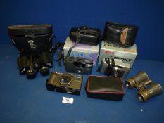 A pair of cased Boots Pacer binoculars, three cameras to include Canon Sure Shot Classic 120,