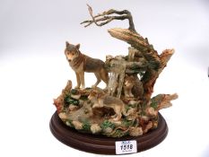 A 'Country Artists' wolf with cubs by a waterfall, 10" tall.
