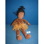 A Norah Wellings Zuzu Islander Rag doll with grass skirt and painted face.