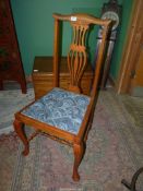 A set of four matching light Oak framed Chairs having shaped top rails,
