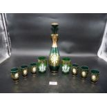 A vintage Bohemian green glass decanter set with six glasses plus two tumblers in similar pattern.