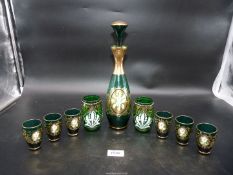 A vintage Bohemian green glass decanter set with six glasses plus two tumblers in similar pattern.