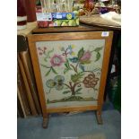 A fire screen having floral embroidered panel.