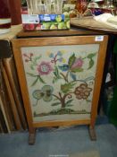 A fire screen having floral embroidered panel.