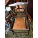 A compact darkwood framed folding open armed Elbow Chair having patent folding action and a brown