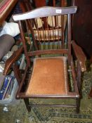 A compact darkwood framed folding open armed Elbow Chair having patent folding action and a brown