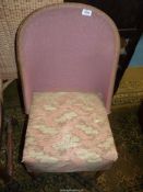 A blush pink Lloyd Loom style chair having an upholstered seat and in original condition.