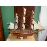 A wooden model of the ship Astrolabe, on wooden stand, 26'' long x 21'' high.