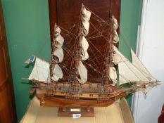 A wooden model of the ship Astrolabe, on wooden stand, 26'' long x 21'' high.