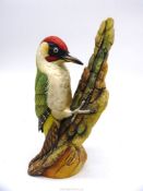 A limited edition figure of a Woodpecker on bark, AP1/15 by Connoisseur of Malvern for H.P.