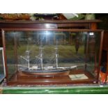 A glazed display case containing a model of The Cutty Sark, 40 1/2" wide x 16" deep x 24" high.