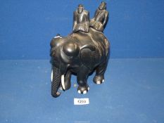 An Ebony elephant with two figures (a/f), 8'' long x 9'' high.