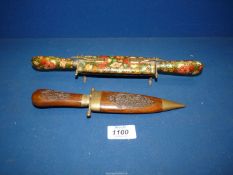 A dagger in a wooden sheath plus a carving set with floral decorated handles and sheath.