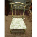 An older painted Bamboo style framed Side Chair having a caned seat and associated white ground