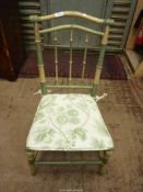 An older painted Bamboo style framed Side Chair having a caned seat and associated white ground
