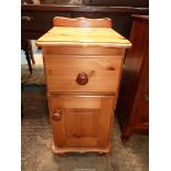 A Pine Bedside Cabinet with a drawer and a raised and fielded panelled door below,