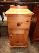 A Pine Bedside Cabinet with a drawer and a raised and fielded panelled door below,