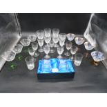 A quantity of champagne coupe glasses with green stems, three Brierley wine glasses,