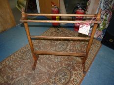 An Arts & Crafts oak towel rail.