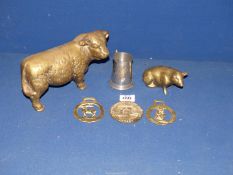 A very heavy brass Hereford Bull, pig and small quantity of horse brasses,