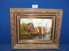 A gilt framed Oil on board depicting a river scene (possibly Brugge), signed lower left 'J.