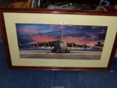 A wooden framed and mounted Print depicting a Boeing C-17, no visible signature, 39 1/2" x 22 1/2".