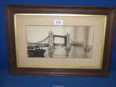 A wooden framed Etching depicting Tower Bridge, no visible signature. 19" x 13".
