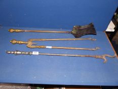 Three brass fire irons to include matching tongs and shovel and a dual pronged poker.