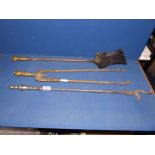 Three brass fire irons to include matching tongs and shovel and a dual pronged poker.