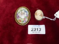 A silver mounted cameo pendant with brooch fastening and a Limoges brooch.
