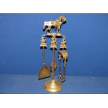 A small brass companion set having horse hunting themed finials, complete with tongs, brush,