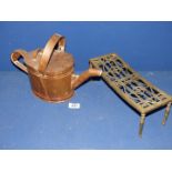 An antique brass trivet and a Copper watering Can with lid.