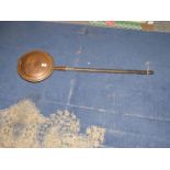 A Copper bed warming pan with turned handle.