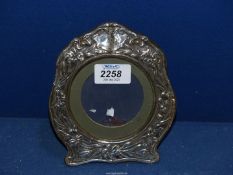 A circular Art Nouveau silver photo frame by Boots Pure Drugs Company dated between 1903 - 1923,