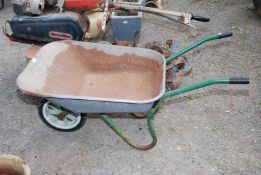A galvanised wheelbarrow with solid tyre.