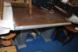 An aluminium based table with wooden top, 50" wide x 34" x 30 1/2" high.
