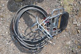 A roll of armoured cable and a motorcycle rack.